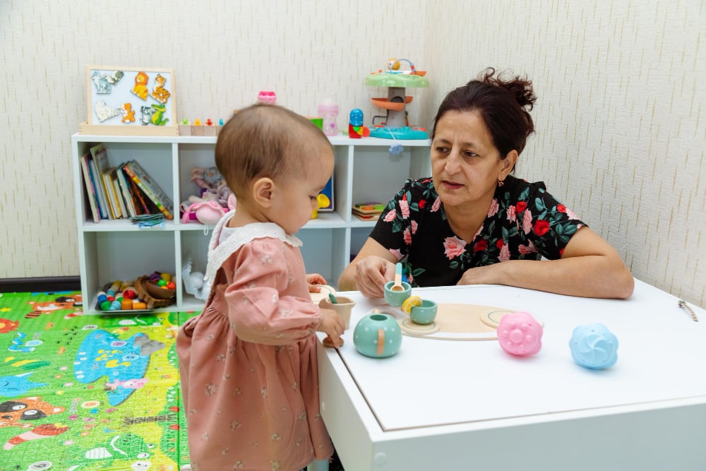 Engaging Playtime Between Grandmother And Granddaughter